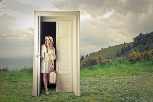 Woman opens the magic door Stock Photo