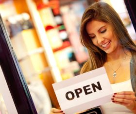 Woman posting a reminder on the door Stock Photo