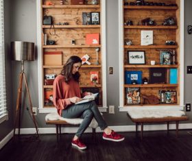 Woman reading book at home Stock Photo