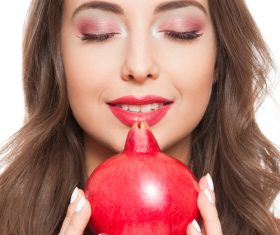 Woman red eye shadow and pomegranate