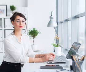 Woman sitting in the office looking out the window Stock Photo