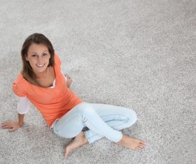 Woman sitting on the carpet Stock Photo