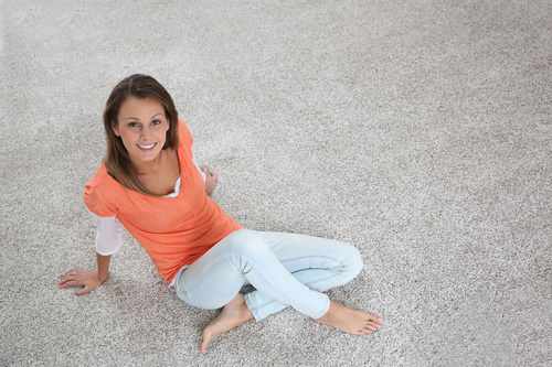 Woman sitting on the carpet Stock Photo