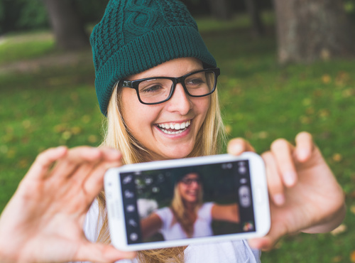 Woman wearing a knitted cap selfie Stock Photo