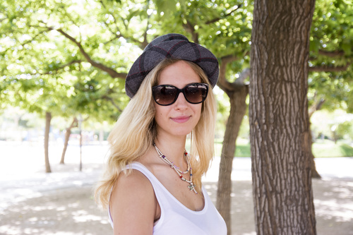 Woman wearing hat and sunglasses in the park Stock Photo