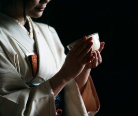 Woman wearing japanese kimono drinking tea Stock Photo