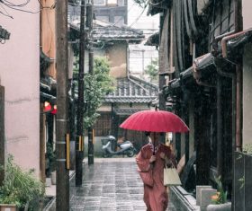 Woman wearing kimono in rainy day holding an umbrella Stock Photo