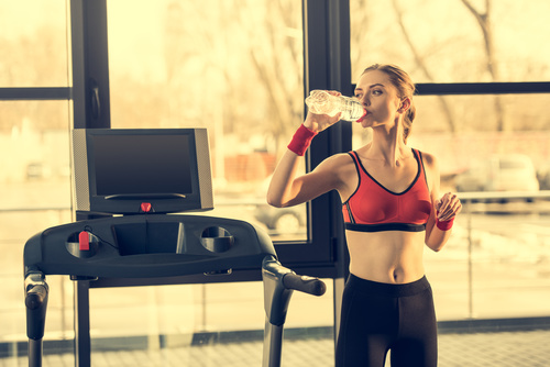 Woman who replenishes water after exercise Stock Photo