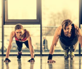 Women push-ups together with coach Stock Photo 01