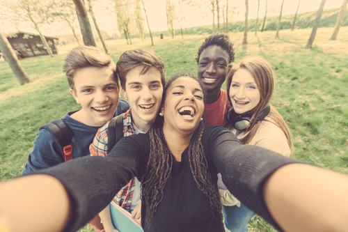 Young friends taking selfies Stock Photo