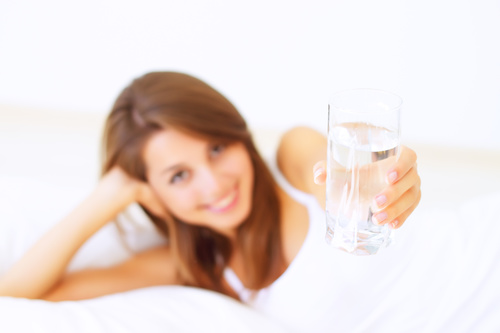 Young girl drinking water in bed Stock Photo 02
