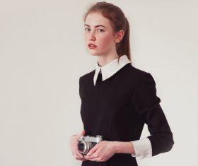 Young girl holding camera Stock Photo