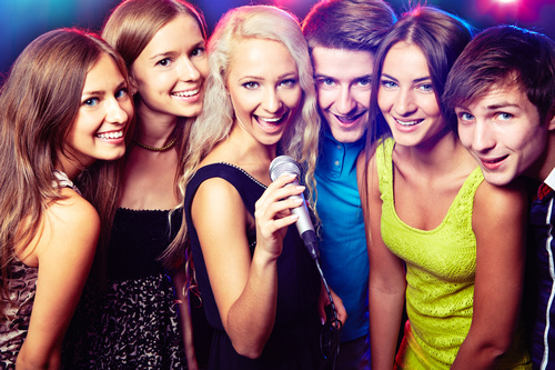 Young people singing together Stock Photo