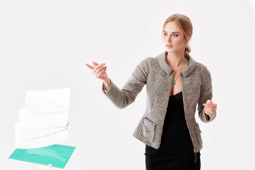 Young pretty businesswoman discarding documents Stock Photo