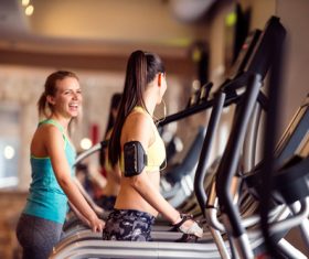 Young woman doing sports on treadmill Stock Photo
