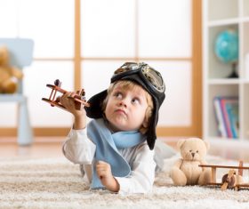 a child playing with a wooden plane Stock Photo 05