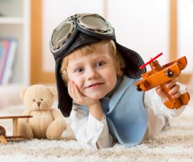 a child playing with a wooden plane Stock Photo 08