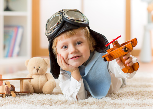 a child playing with a wooden plane Stock Photo 08