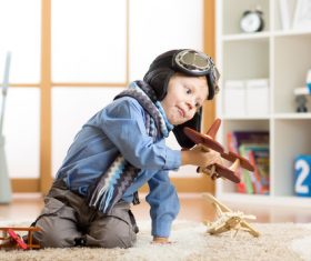 a child playing with a wooden plane Stock Photo 10