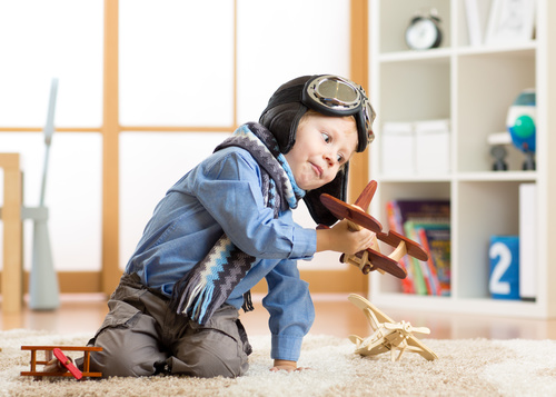 a child playing with a wooden plane Stock Photo 10