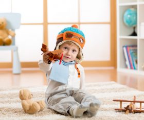 a child playing with a wooden plane Stock Photo 11