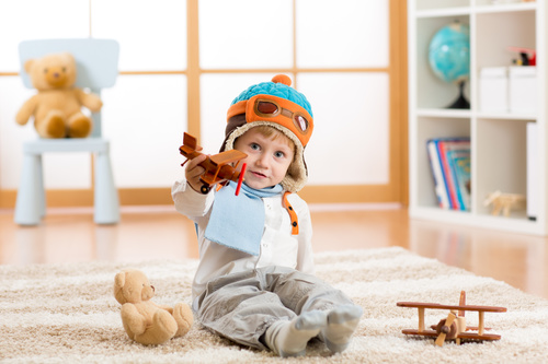 a child playing with a wooden plane Stock Photo 11