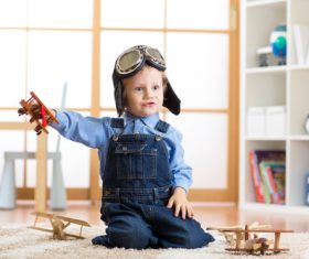 a child playing with a wooden plane Stock Photo 12
