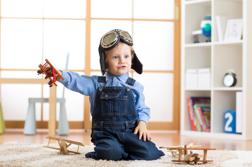 a child playing with a wooden plane Stock Photo 12