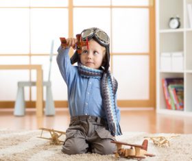 a child playing with a wooden plane Stock Photo 13