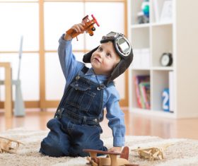 a child playing with a wooden plane Stock Photo 14