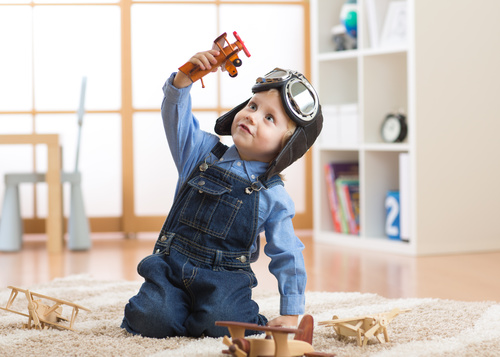 a child playing with a wooden plane Stock Photo 14