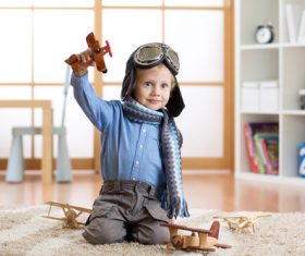 a child playing with a wooden plane Stock Photo 15