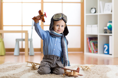 a child playing with a wooden plane Stock Photo 15