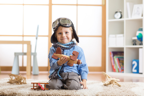 child playing with toy airplane at home Stock Photo 03