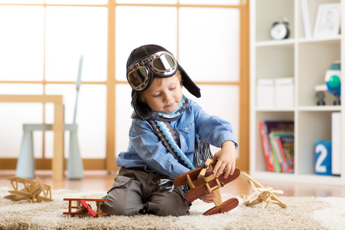 child playing with toy airplane at home Stock Photo 04