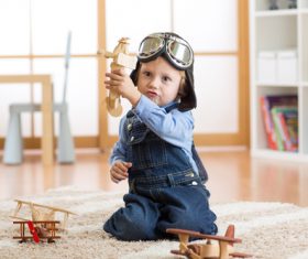 child playing with toy airplane at home Stock Photo 05
