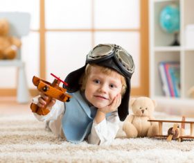 child playing with toy airplane at home Stock Photo 06