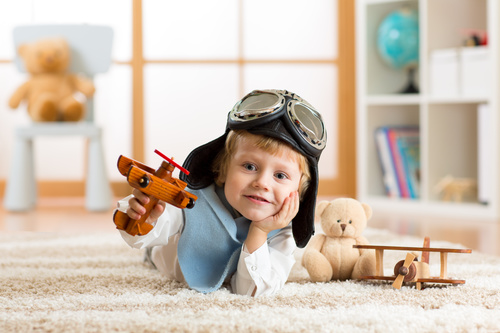 child playing with toy airplane at home Stock Photo 06