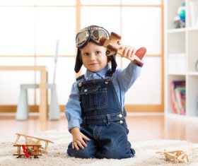 child playing with toy airplane at home Stock Photo 07
