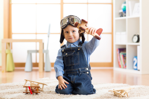child playing with toy airplane at home Stock Photo 07