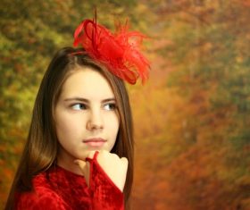 girl posing with red bow on hair Stock Photo