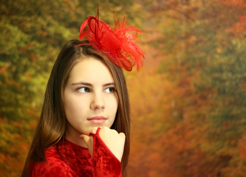 girl posing with red bow on hair Stock Photo