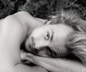 man lying on the grass Stock Photo