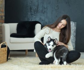 puppies husky and girl play Stock Photo