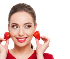woman who uses strawberries as earrings