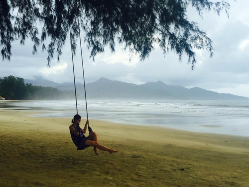 young woman relaxing swing seaside Stock Photo