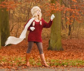 Autumn woman in warm clothes is doing sports Stock Photo