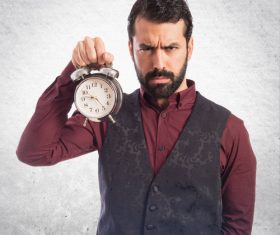 Bearded Man holding an alarm clock Stock Photo