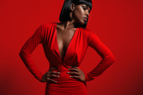 Black skinned woman in red evening gown Stock Photo