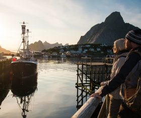Couple standing on the pier in the Norwegian Bay Stock Photo